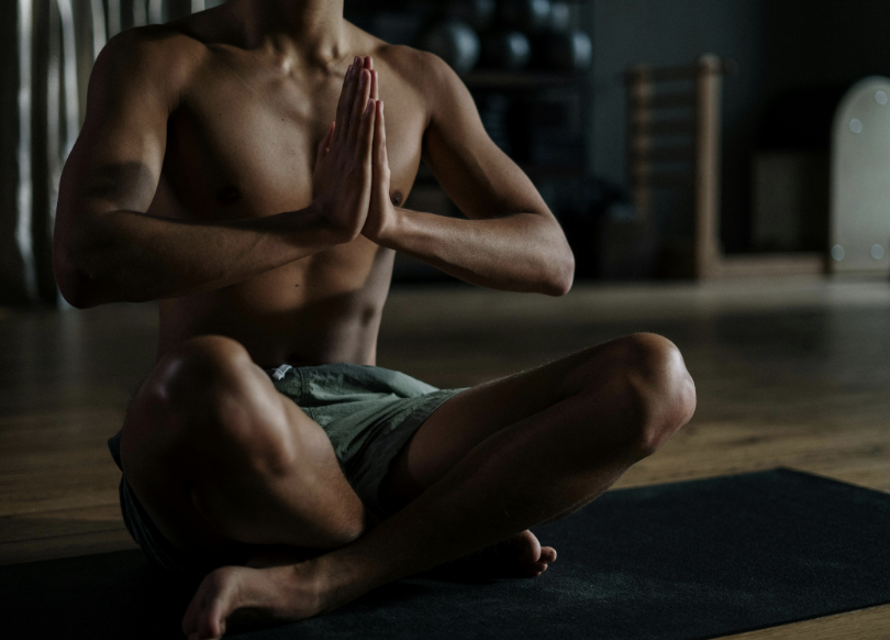 Person practicing yoga on mat