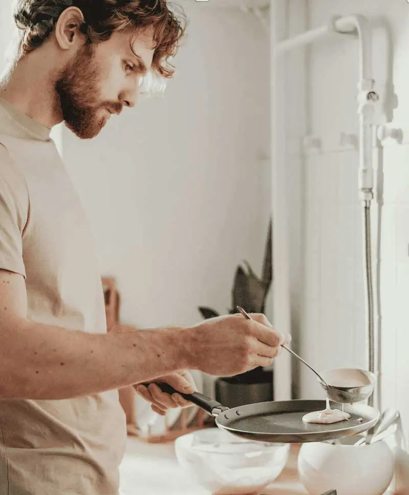 Individual preparing food in modern kitchen