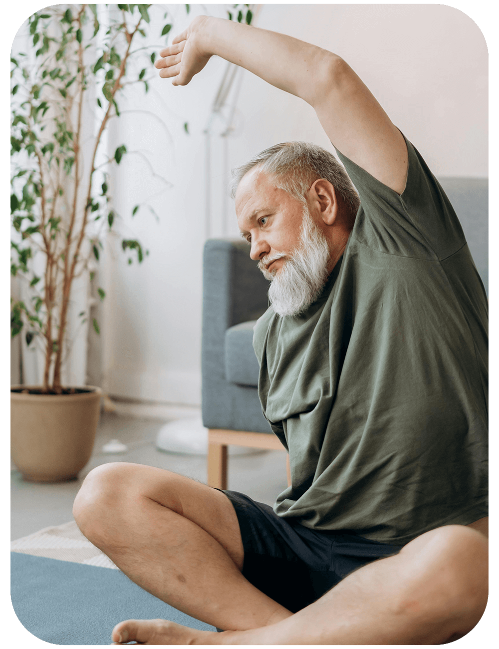 Senior practicing yoga in living room