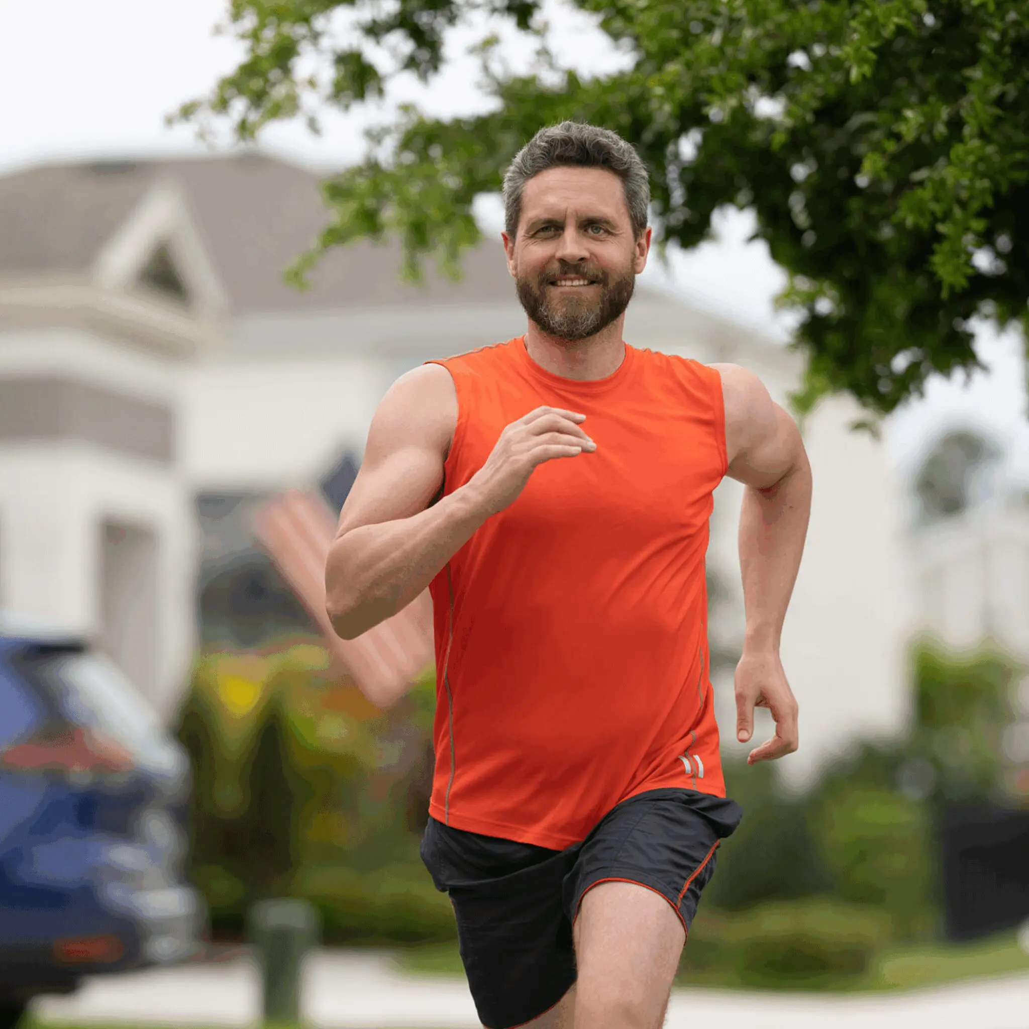 Bearded man jogging in orange shirt